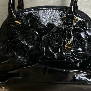Big Buddha black bag. Roses decorations on front.